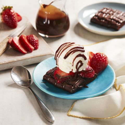 A Hot Fudge Brownie Sundae, made with Fibre One™ 90 Calorie Chocolate Fudge Brownies, on a blue plate